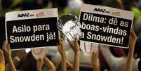 Brasileiros erguem placas pedindo para que o Brasil abrigue Edward Snowden  Foto: Reuters