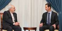 Assad reunido com o chanceler sírio, Javad Zarif  Foto: AP