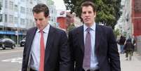 <p>Os irmãos gêmeos Cameron e Tyler Winklevoss ainda preveem que este ano o mercado financeiro de Wall Street deve entrar no mercado dos bitcoins</p>  Foto: Getty Images 