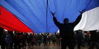  Manifestantes pró-Rússia participam de marcha durante protesto em frente ao prédio do governo da Crimeia. De acordo com o Ministro do Interior ucraniano, a polícia está em alerta máximo depois que dezenas de manifestantes invadiram o edifício do Parlamento de Simferopol  Foto: AP