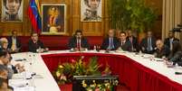 Reunião contou com a presença do presidente Nicolás Maduro e de representantes da oposição, além de chanceleres da Unasul e do núncio apostólico do Vaticano  Foto: EFE
