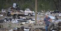 Homem recupera o pneu de um trailer destruído por tempestades em Mayflower, no Arkansas, Estados Unidos, nesta terça-feira. 29/04/2014  Foto: Carlo Allegri / Reuters