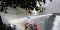 Tropas de choque usam canhões de água para dispersar estudantes durante um protesto para exigir mudanças no sistema de educação chileno  Foto: Ivan Alvarado / Reuters