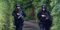 <p>Homens fortemente armados buscam por suspeito em vila da Cornualha</p>  Foto: Daily Mail / Reprodução