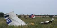 <p>Destroços do vôo MH17 da Malaysia Airlines são vistos nesta sexta-feira, 18 de julho, em Shaktarsk, leste da Ucrânia</p>  Foto: Dominique Faget / AFP