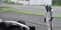 <p>Felipe Massa observa estrago em seu carro e deixa corrida bastante chateadoapós batida com Magnussen</p>  Foto: Patrick Stollarz / AFP