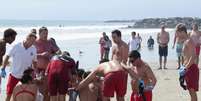 <p>Vítima é socorrida pela equipe de resgate após raio atingir praia</p>  Foto: Jonathan Alcorn / Reuters