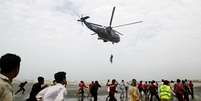 <p>Helicóptero da Marinha do Paquistão retira o corpo de uma vítima que se afogou na praia de Clifton, em Karachi, no Paquistão, nesta quinta-feira, 31 de julho</p>  Foto: Fareed Khan / AP