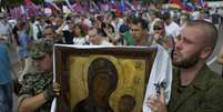 <p>Manifestantes carregam uma imagem da&nbsp;Virgem Maria,&nbsp;um dos &iacute;cones mais importantes dos russos ortodoxos, durante com&iacute;cio em Moscou</p>  Foto: Ivan Sekretarev / AP