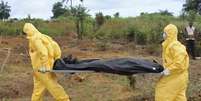 <p>Profissionais de saúde levam o corpo de pessoa que morreu devido ao vírus ebola em Fretown, Serra Leoa, em 21 de outubro</p>  Foto: Josephus Olu-Mamma / Reuters