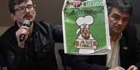 Chargistas apresentam a edição de amanhã do Charlie Hebdo   Foto: AFP
