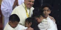 Papa Francisco abraça crianças em encontro na Universidade de São Tomás de Manila, nas Filipinas  Foto: Romeo Ranoco / Reuters