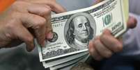 <p>Dólar caiu 0,39% nesta quinta-feira, a R$ 3,1909</p>  Foto: Beawiharta / Reuters