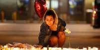 Mulher acende velas para vítimas de ataque em festival de música, em Las Vegas 02/10/2017 REUTERS/Chris Wattie  Foto: Reuters