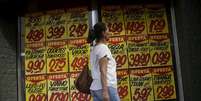 Consumidora passa por cartazes com preços de produtos em mercado no Rio de Janeiro 09/12/2017 REUTERS/Ricardo Moraes  Foto: Reuters