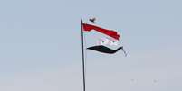 Bandeira rasgada da Síria é vista na cidade de Qamishli  Foto: Rodi Said / Reuters
