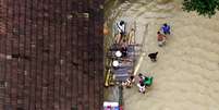 Pessoas esperam pelo resgate aéreo no sul de Kerala, na Índia  Foto: Sivaram V / Reuters