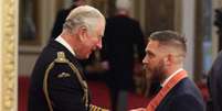 Tom Hardy recebe condecoração do príncipe Charles.  Foto: Twitter / @RoyalFamily / Estadão