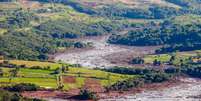 Lama varreu a região abaixo da barragem, e continua avançando  Foto: Cadu Rolim/Fotoarena / Estadão Conteúdo