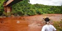 Indígena observa o rio Paraopeba tomado pela lama  Foto: Funai/Divulgação/via EFE / Estadão Conteúdo