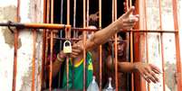 Presos gesticulam na Penitenciária de Pedrinhas, no Maranhão, em 2014  Foto: Márcio Fernandes de Oliveira / Estadão