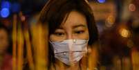 Woman wearing face mask  Foto: AFP / BBC News Brasil