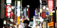 Homem com m&aacute;scara de prote&ccedil;&atilde;o contra coronav&iacute;rus caminha pelas ruas de T&oacute;quio
27/03/2020
REUTERS/Issei Kato  Foto: Reuters