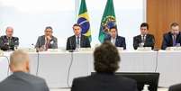 Bolsonaro em reunião com integrantes do governo — entre eles Sergio Moro, de braços cruzados à direita, cujas acusações contra o presidente ao deixar ministério motivaram inquérito  Foto: Marcos Corrêa/Presidência da República / BBC News Brasil