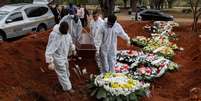 Coveiros se preparam para sepultar mulher que morreu com suspeita de ter sido infectada pelo novo coronavírus, no cemitério de Vila Formosa, em São Paulo
16/07/2020
REUTERS/Amanda Perobelli  Foto: Reuters