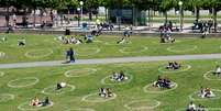 Em Düsseldorf, círculos marcados no gramado de um parque ajudam a manter o distanciamento entre as pessoas.   Foto: DW / Deutsche Welle