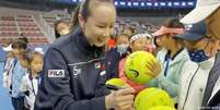 Primeira imagem credível em semanas de Peng Shuai: a tenista distribuiu autógrafos num torneio infantil em Pequim  Foto: DW / Deutsche Welle