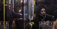 Foto mostra uma mulher negra dentro de um ônibus.  Foto: Imagem: Reprodução / Minas da Periferia / Alma Preta