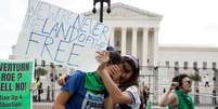 Mulheres choram na frente da Suprema Corte dos EUA, em Washington, após decisão sobre direito ao aborto  Foto: Getty Images / BBC News Brasil