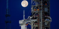 Imagem do nariz do foguete Artemis-i SLS com a cápsula Orion no pórtico de lançamento à luz da Lua  Foto: Getty Images / BBC News Brasil