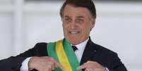 Jair Bolsonaro (PL) com a faixa presidencial; presidente não passará a faixa para Luiz Inácio Lula da Silva (PT)  Foto: Agência Brasil