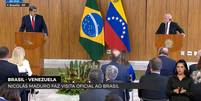 Imagem mostra Lula, à direita, e Maduro, à esquerda. Ambos vestem ternos escuros, estão atrás de pulpitos de madeira e são observados por uma plateia. Entre eles aparecem as bandeiras do Brasil e da Venezuela.  Foto: Aos Fatos