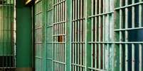 Para ilustrar o caso do homem negro preso acusado de tráfico, imagem mostra o corredor de uma prisão e as grades verdes das celas.  Foto: Imagem: Thinkstock / Alma Preta