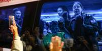 Reféns libertados pelo Hamas no domingo em um ônibus que os transporta para uma base militar em Ofakim, no sul de Israel  Foto: Getty Images / BBC News Brasil