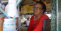 Oriana em sua barraca de comida venezuelana em Georgetown  Foto: BBC News Brasil