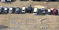 Sigla 'SOS' foi escrita no chão com cadeiras numa universidade na cidade de Noto  Foto: Reuters / BBC News Brasil