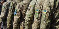 Soldados ucranianos em desfile militar. Bandeira ucraniana no uniforme militar  Foto: Foto: istock