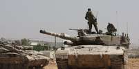 Tropas israelenses em cima de um tanque de guerra.  Foto: EPA / BBC News Brasil