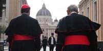 O cardeal canadense Thomas Christopher Collins (à direita) e o cardeal canadense Francis Leo caminham pela rua Via della Conciliazione, perto do Vaticano, com a Basílica de São Pedro ao fundo, em Roma, em 5 de maio de 2025. (Foto de Dimitar DILKOFF / AFP)  Foto: AFP - DIMITAR DILKOFF / RFI