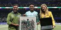  Foto: Divulgação/Palmeiras - Legenda: Estêvão recebe uma placa das mãos da presidente Leila Pereira / Jogada10