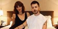 Monica Benini e Junior Lima posam juntos em um quarto de hotel  Foto: Reprodução | Instagram