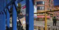 Trabalhador carrega materiais para eleição, em El Alto, na Bolívia 16/08/2025  Foto: REUTERS/Claudia Morales