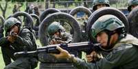 Soldados participam de um exercício liderado pelas Forças Armadas Nacionais Bolivarianas para treinar civis no manuseio de armas, após o presidente da Venezuela, Nicolás Maduro, mobilizar o Exército em comunidades de todo o país como parte de uma iniciativa nacional voltada à capacitação de cidadãos e moradores, em meio ao aumento das tensões com os Estados Unidos, em Yagua, Venezuela.  Foto: REUTERS - Juan Carlos Hernandez / RFI