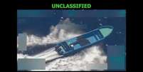 Imagem de câmera de vigilância mostra um barco azul e comprido navegando em alta velocidade pela água, com ondas ao redor; acima da foto, texto diz: 'não classificado'  Foto: Reprodução/Pete Hegseth/X / BBC News Brasil