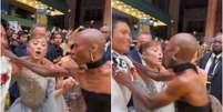Momento em que o fã invade o tapete, agarra Ariana Grande e é afastado por Cynthia Erivo  Foto: Reprodução de vídeo/@lanagrandes via X / Estadão