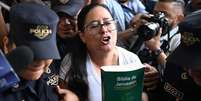 A advogada e ativista dos direitos humanos salvadorenha Ruth López, escoltada pela polícia para uma audiência no centro judicial Isidro Menéndez, na capital San Salvador, no dia 4 de junho de 2025  Foto: Getty Images / BBC News Brasil